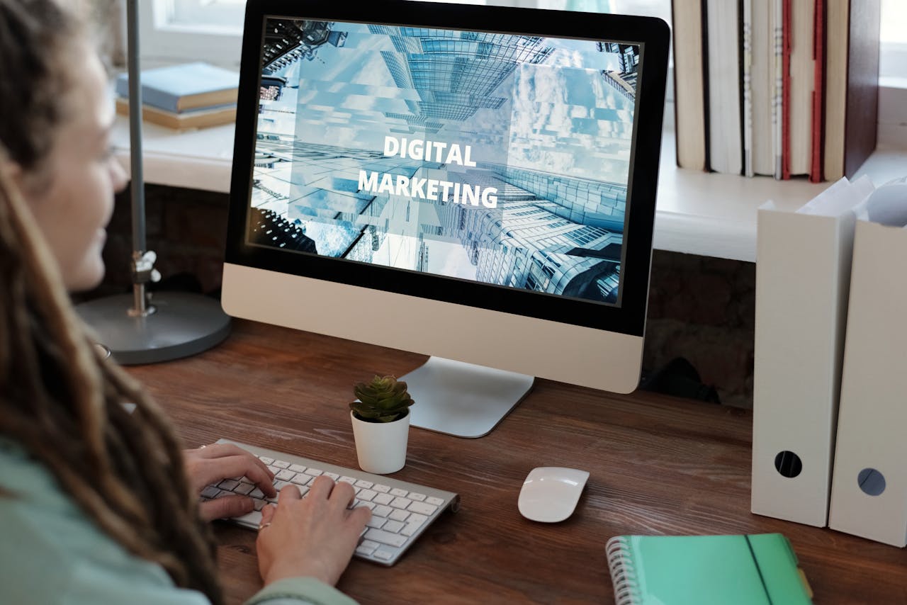 Close-up of a woman working on a digital marketing project in a home office setting.